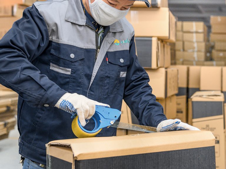 a worker packing the baby cribs