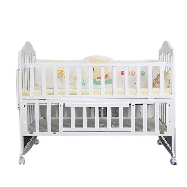 A Wooden White Baby Cot Bed with Storage